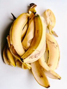 a bunch of bananas on a white surface - banana peel benefits